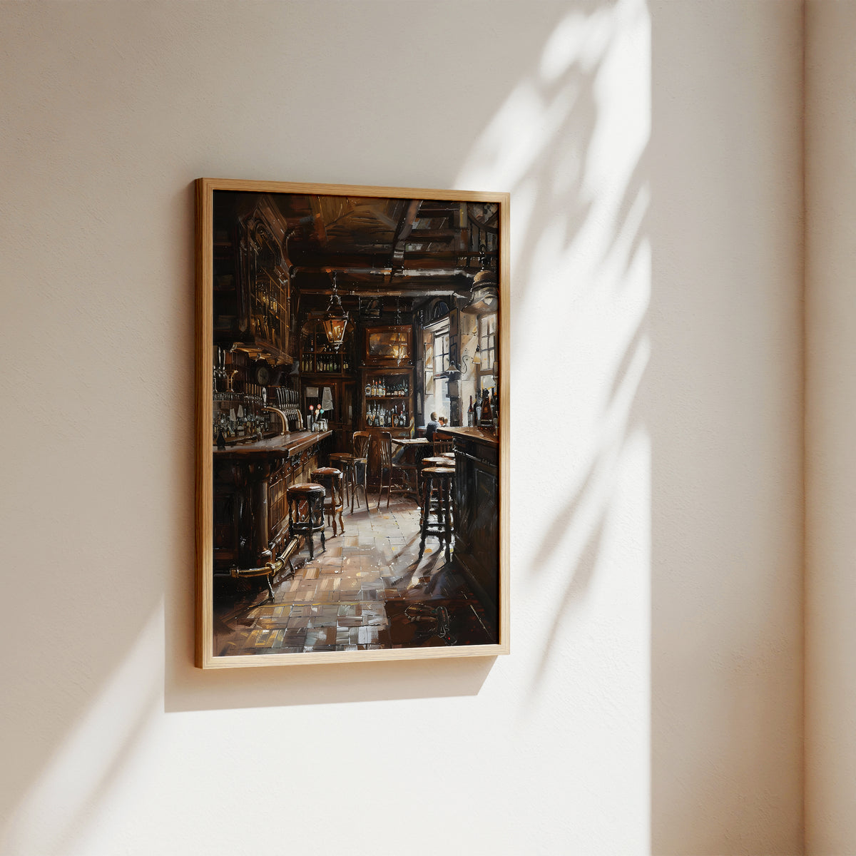 A framed art print depicting a moody, dimly lit bar interior with warm amber and brown tones, hung on a beige wall with soft sunlight and leaf shadows cast across it.