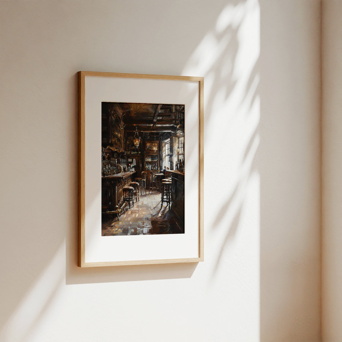 A framed art print depicting a moody, dark interior bar scene, mounted on a warm beige wall with soft sunlight and leaf shadows cast across it.