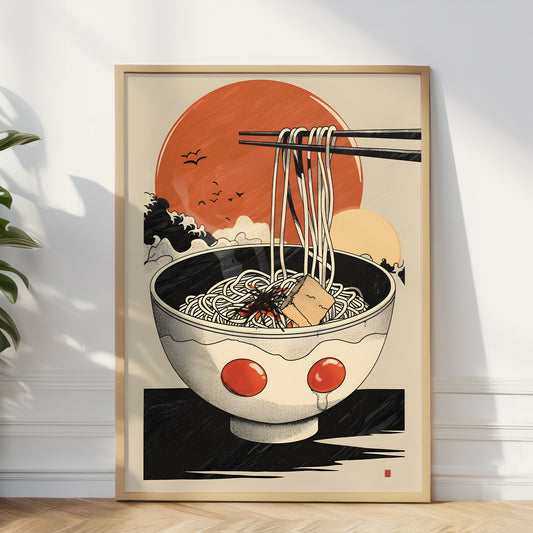 A framed art print depicting a bowl of ramen with chopsticks lifting noodles, shown leaning against a white wall on a light wood floor.