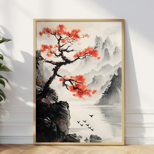 A framed vertical art print depicting a traditional Chinese landscape with a vibrant red tree, misty mountains, water, and birds, leaning against a white wall on a light wood floor.