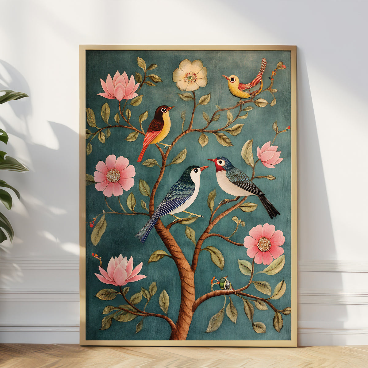 A framed vertical art print leaning against a white wall on a light wood floor, featuring an illustrated floral scene with pink blossoms, green leaves, and several colorful birds on brown branches.