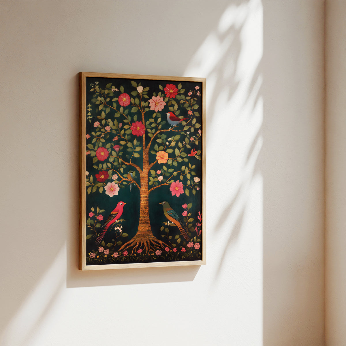 A framed art print featuring a stylized tree of life with colorful flowers and birds, displayed on a warm beige wall with soft sunlight and leaf shadows.