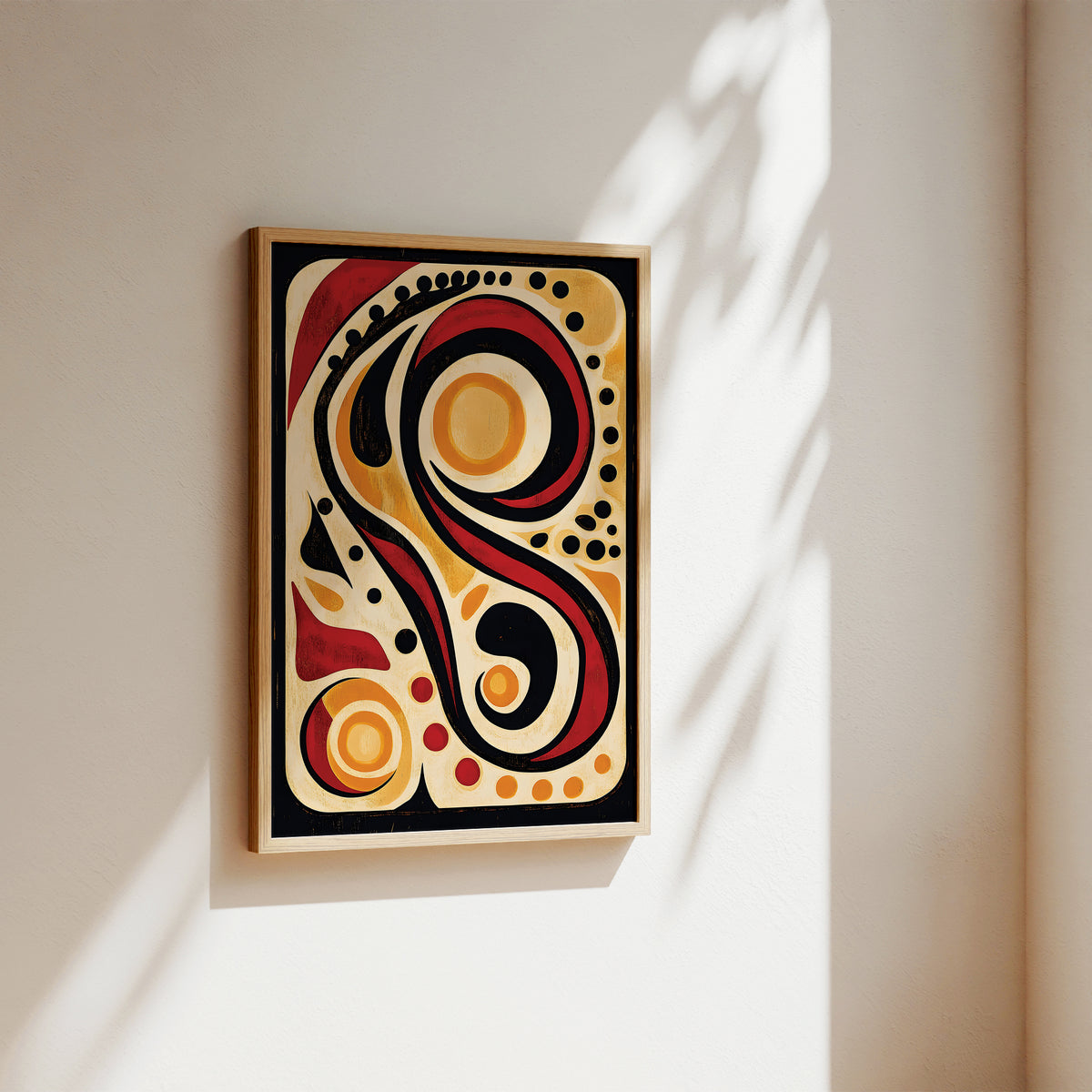 Abstract framed wall art hanging on a warm beige wall, with sunlight casting soft shadows across the artwork and surrounding wall.