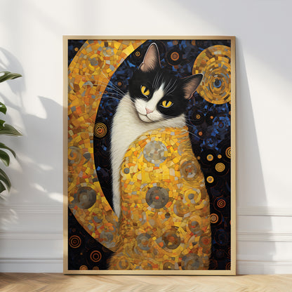 A framed art print featuring a black and white cat in a gold mosaic design, leaning against a white wall on a light wood floor next to a green plant.