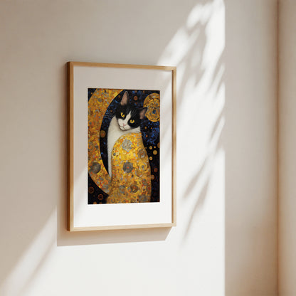 A framed art print featuring a stylized black and white cat in a gold patterned dress, hanging on a warm beige wall with soft sunlight and leaf shadows.