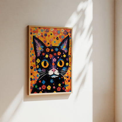 A framed colorful pop-art style cat painting hanging on a warm beige wall, with sunlight casting leaf shadows across the wall and frame.