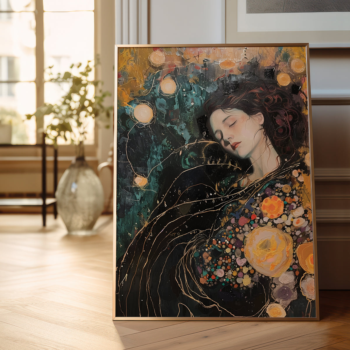 A framed vertical painting leaning against a wall in a bright, modern room. The artwork depicts a woman with closed eyes, dark wavy hair, and a dark dress adorned with large yellow, orange, and pink flowers, set against a dark teal and gold abstract background with glowing orbs.