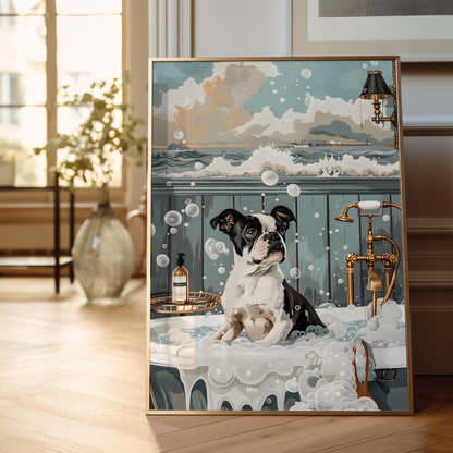 A framed vertical art print leaning against a wall on a wooden floor in a bright room. The artwork shows a black-and-white dog sitting in a bathtub filled with bubbles, with an ocean scene and cloudy sky above.