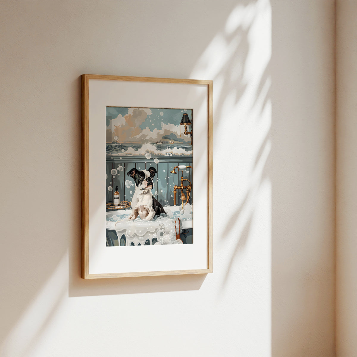 A framed art print featuring a whimsical illustration of a woman in a white dress and a black-and-white dog on a balcony, hung on a warm beige wall with soft sunlight and leaf shadows.