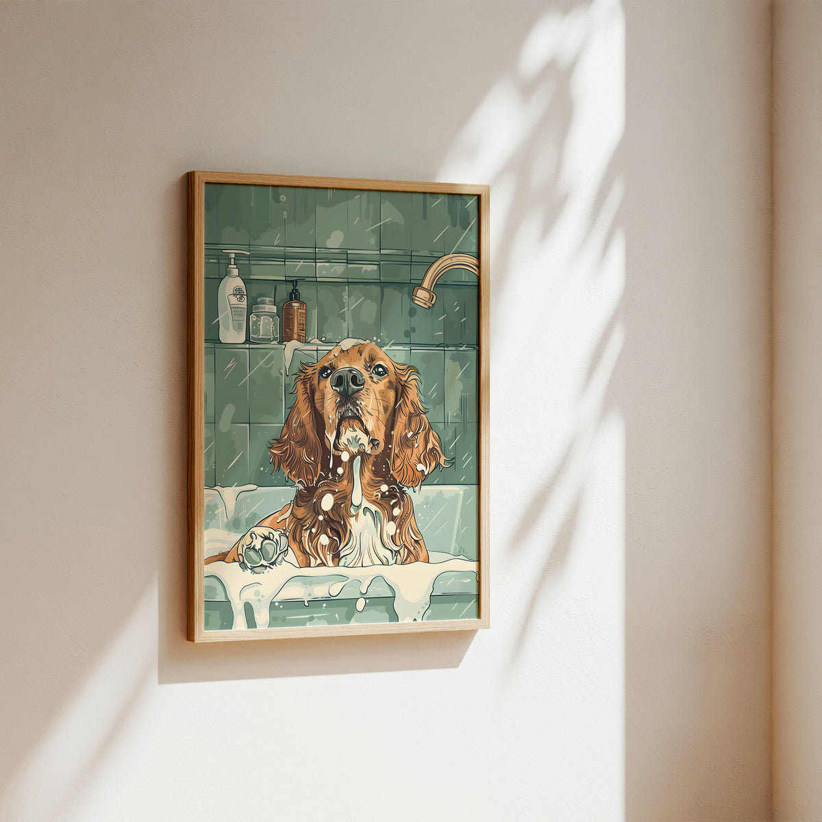 A framed art print depicting a brown and white dog sitting in a bathtub with soap, hanging on a beige wall with soft sunlight and leaf shadows.