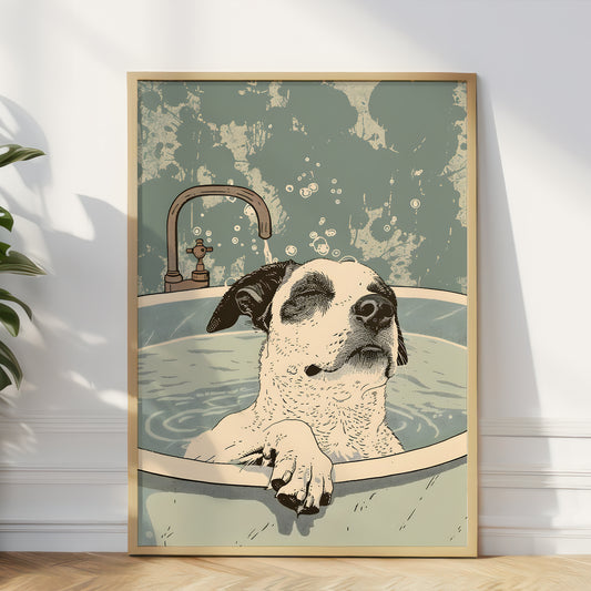 A framed art print featuring a humorous illustration of a dog sitting in a bathtub, leaning against a white wall on a light wood floor next to a green plant.
