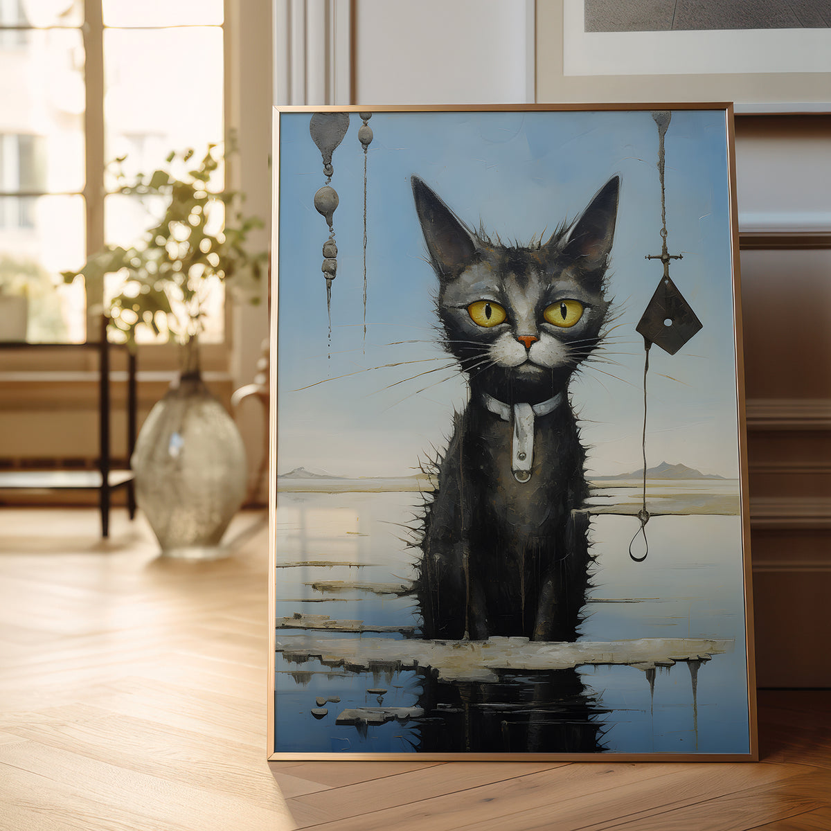 A framed surreal art print depicting a black cat with yellow eyes standing in shallow water, leaning against a wall on a wooden floor in a softly lit room.