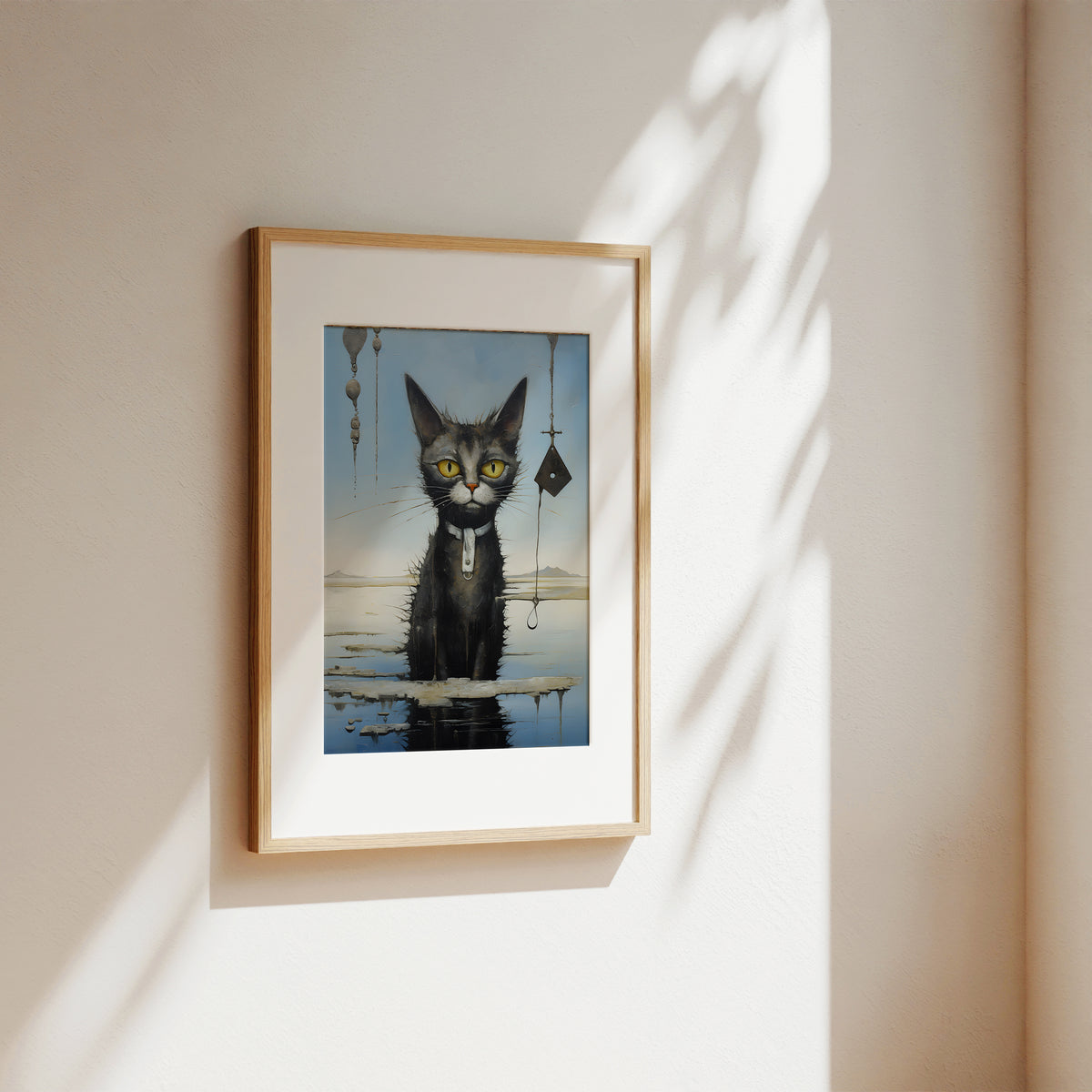 A framed art print featuring a black cat with yellow eyes standing in water, hung on a beige wall with soft sunlight and leaf shadows.