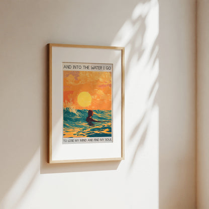 Framed artwork with a sunset and ocean design on a wall.