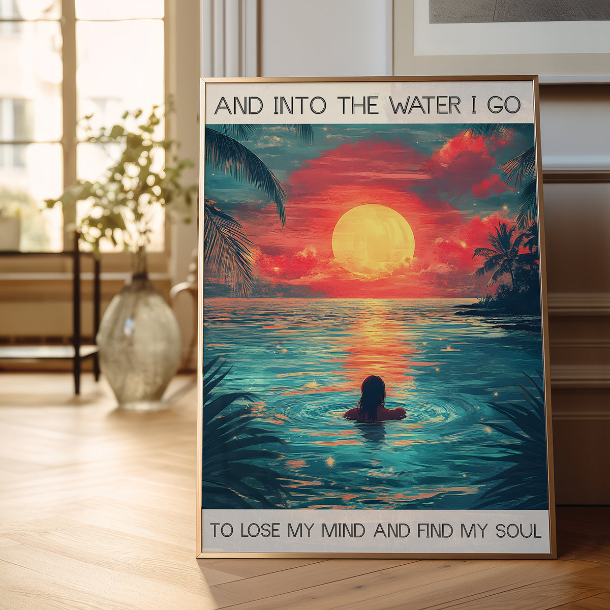 Poster of a sunset over water with a person swimming, placed on a wooden floor.