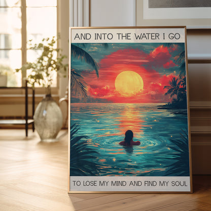 Poster of a sunset over water with a person swimming, placed on a wooden floor.
