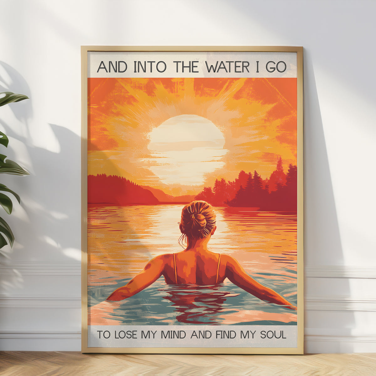Framed artwork of a woman in water with sunset and text on a white wall.