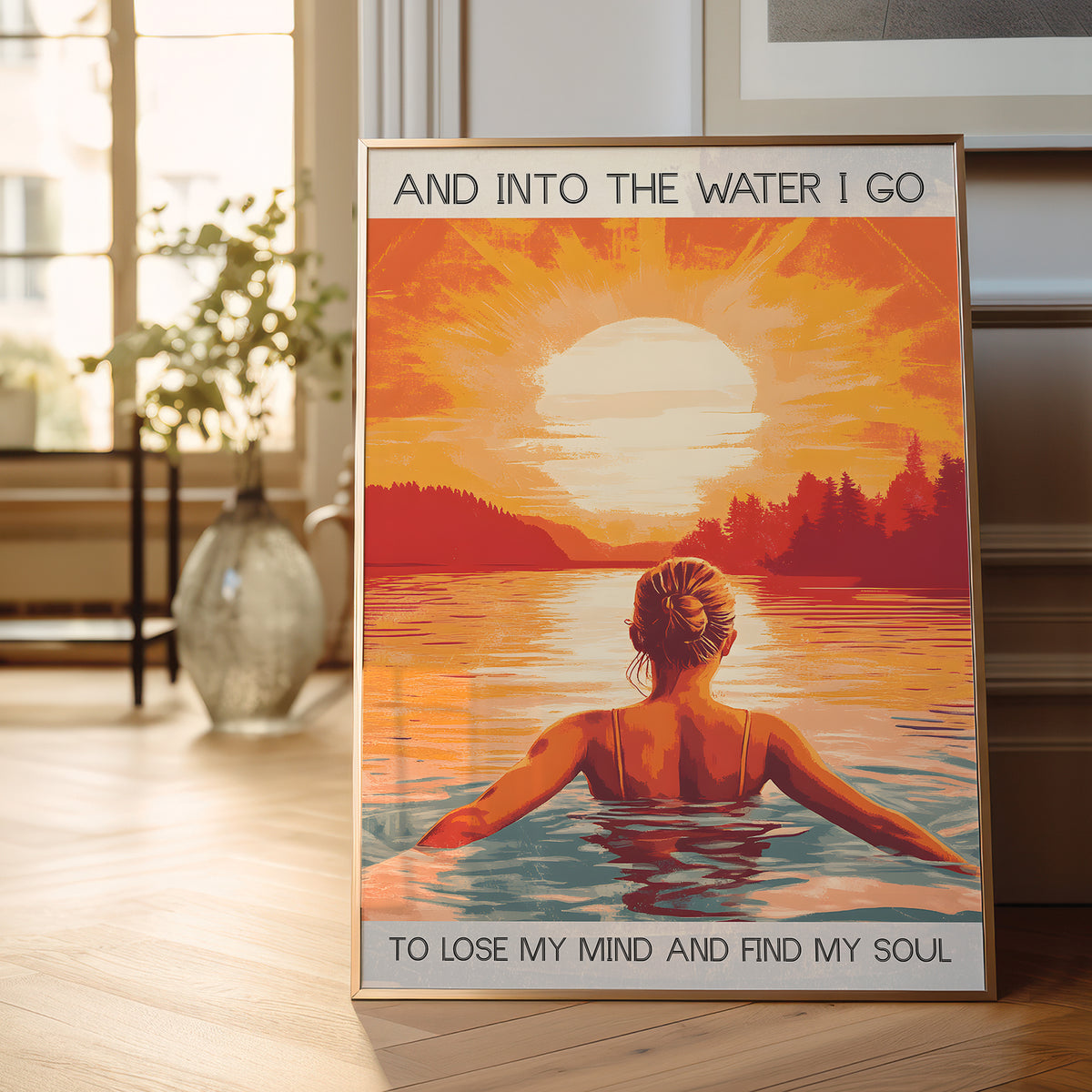 Framed poster of a woman in water with sunset and text in a room.