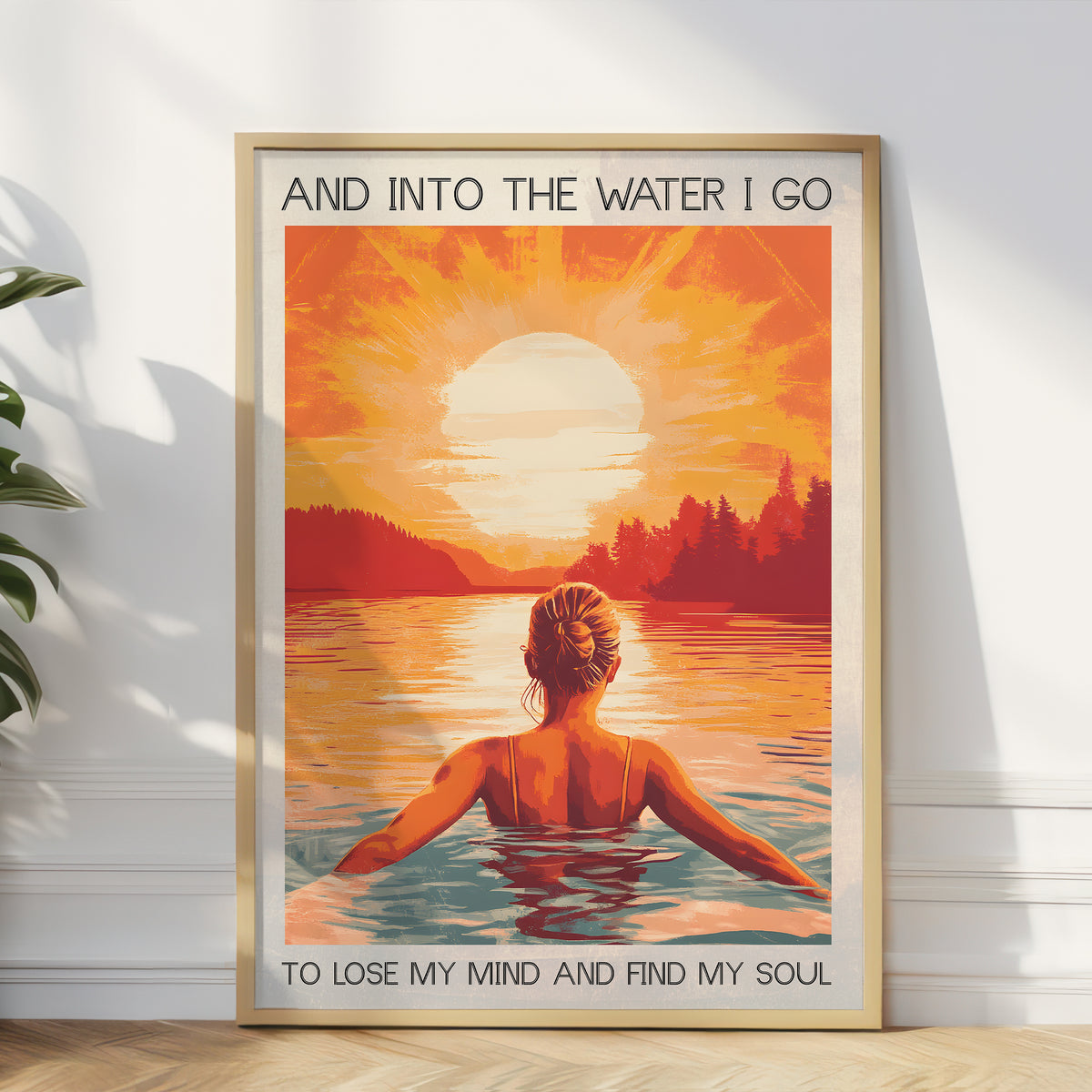 Framed artwork of a woman in water with a sunset and nature scene, text 'And into the water I go To lose my mind and find my soul'.