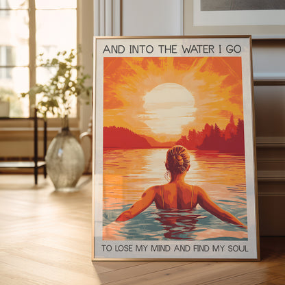 Framed poster of a woman in water with sunset and text in a room.