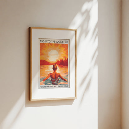 Framed artwork of a person in water with a sunset and text on a beige wall.