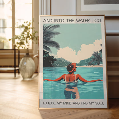 Framed poster of a woman in a pool with a scenic background, placed on a wooden floor.