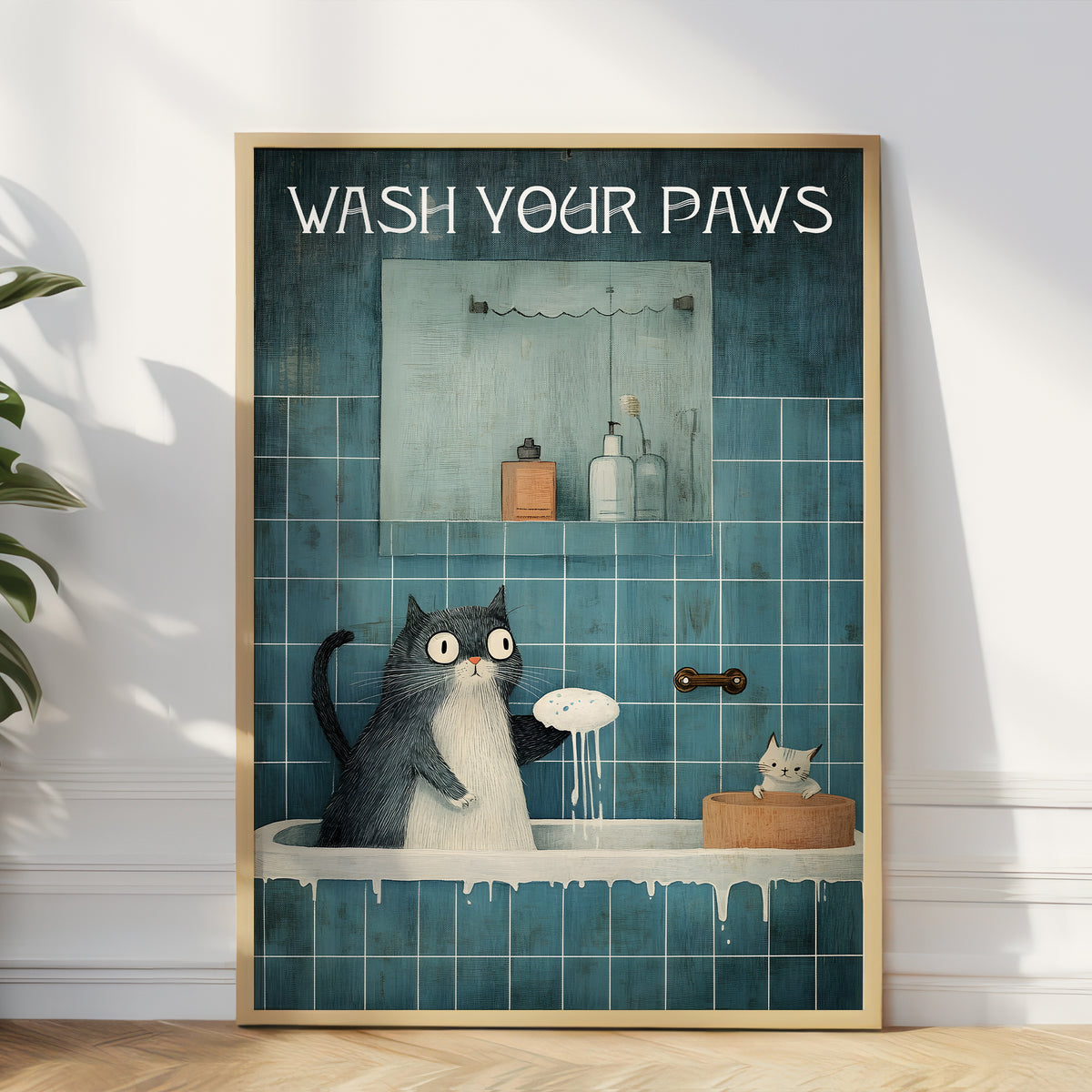 Framed artwork of a cat in a bathroom with 'Wash Your Paws' text.