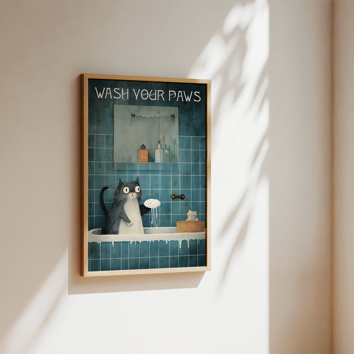 Framed artwork of a cat washing its paws with text 'Wash Your Paws' on a wall.