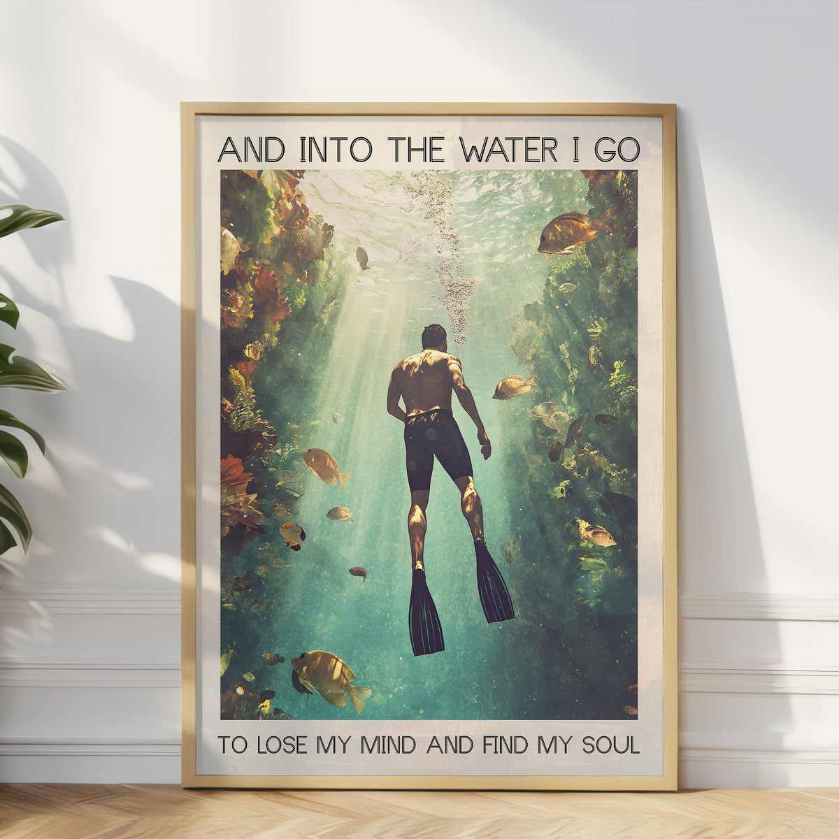 Framed poster of a diver underwater with text on a wall.