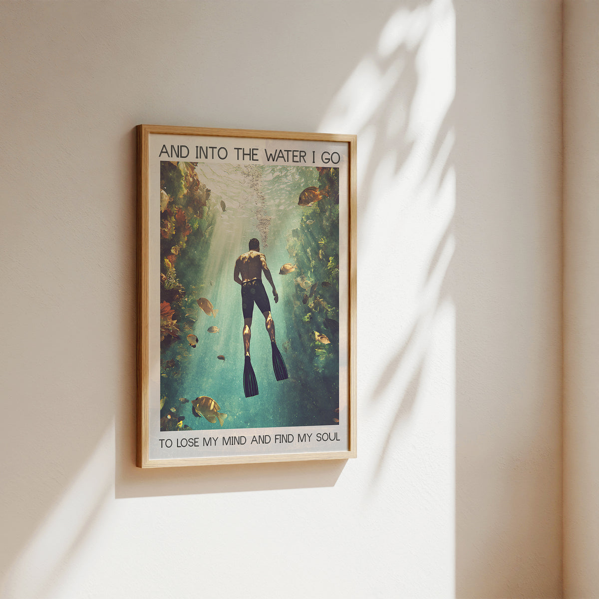 Framed poster of a diver underwater with text on a wall.