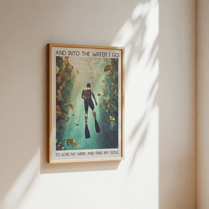 Framed poster of a diver underwater with text on a wall.