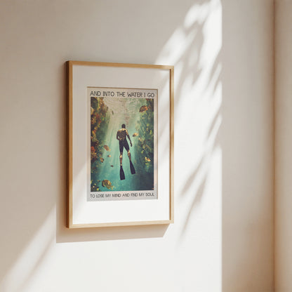 Framed poster of a diver underwater with text on a beige wall.