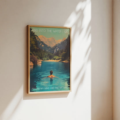 Framed artwork of a person swimming in a mountain lake with text on a wall.