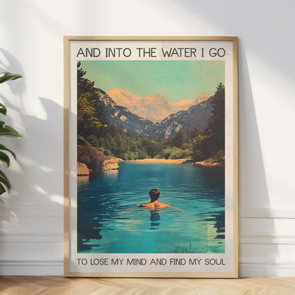 Framed poster of a person swimming in a mountain lake with text on a white wall.