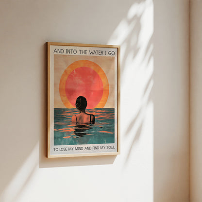 Framed artwork with a sunset and person in water design on a wall.