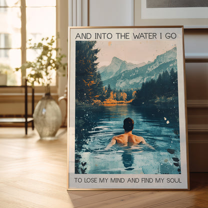 Framed poster of a person in a lake with mountains and text in a room.