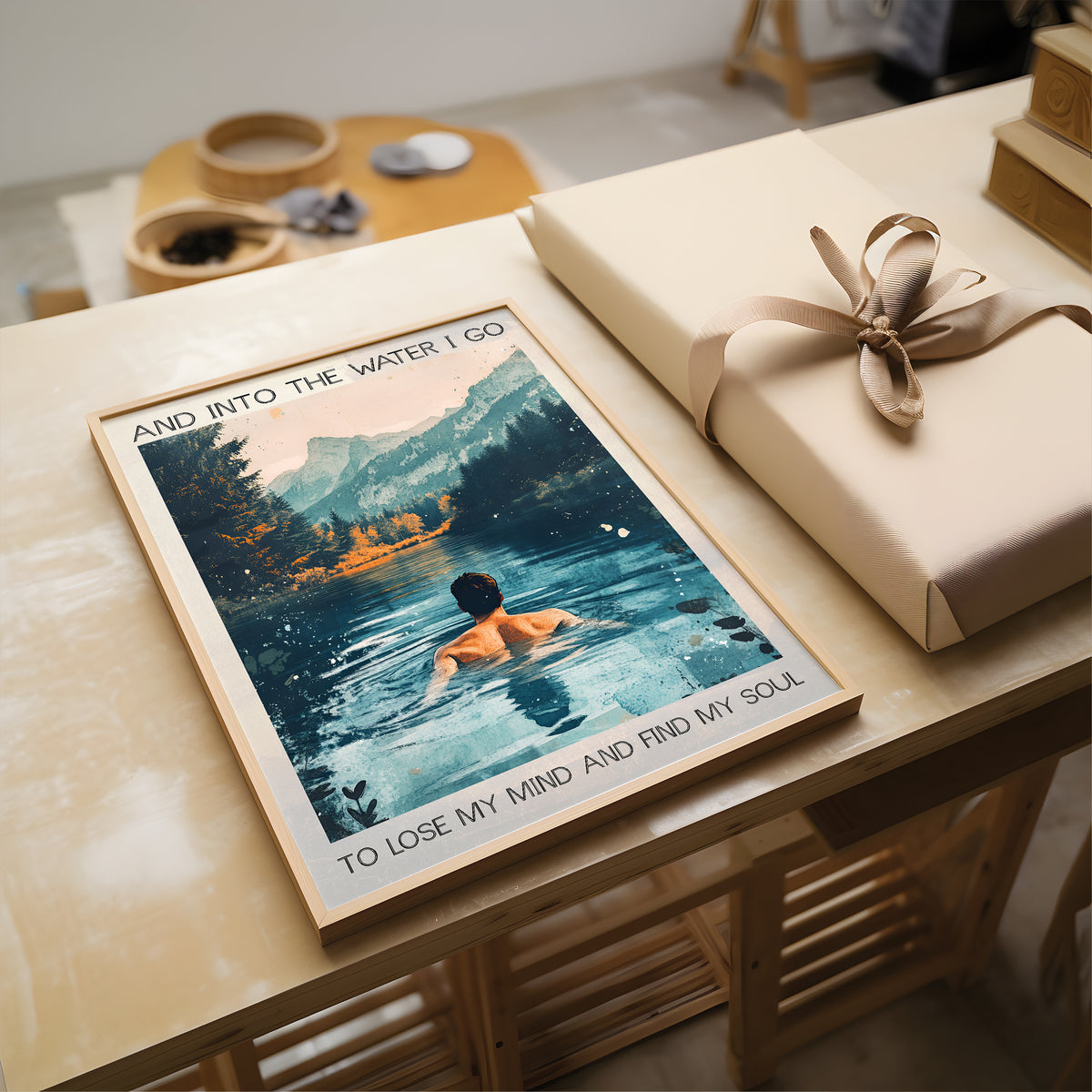 Poster of a person in water with text on a table next to a wrapped gift.