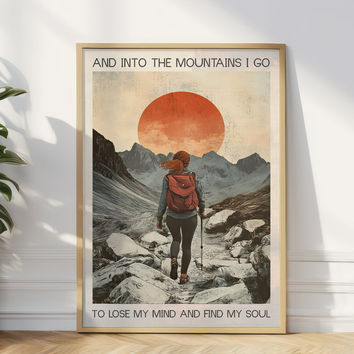 Framed poster of a person hiking with mountains and sunset in the background.