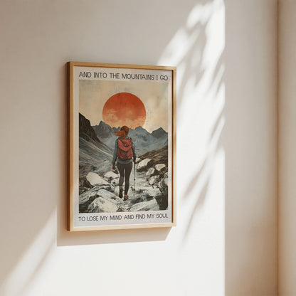 Framed poster of a mountain scene with text on a wall.