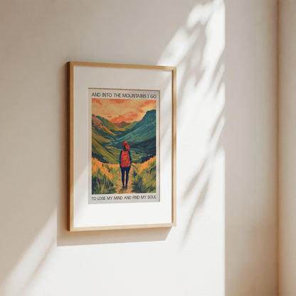 Framed artwork of a mountain scene with a person and text on a beige wall.