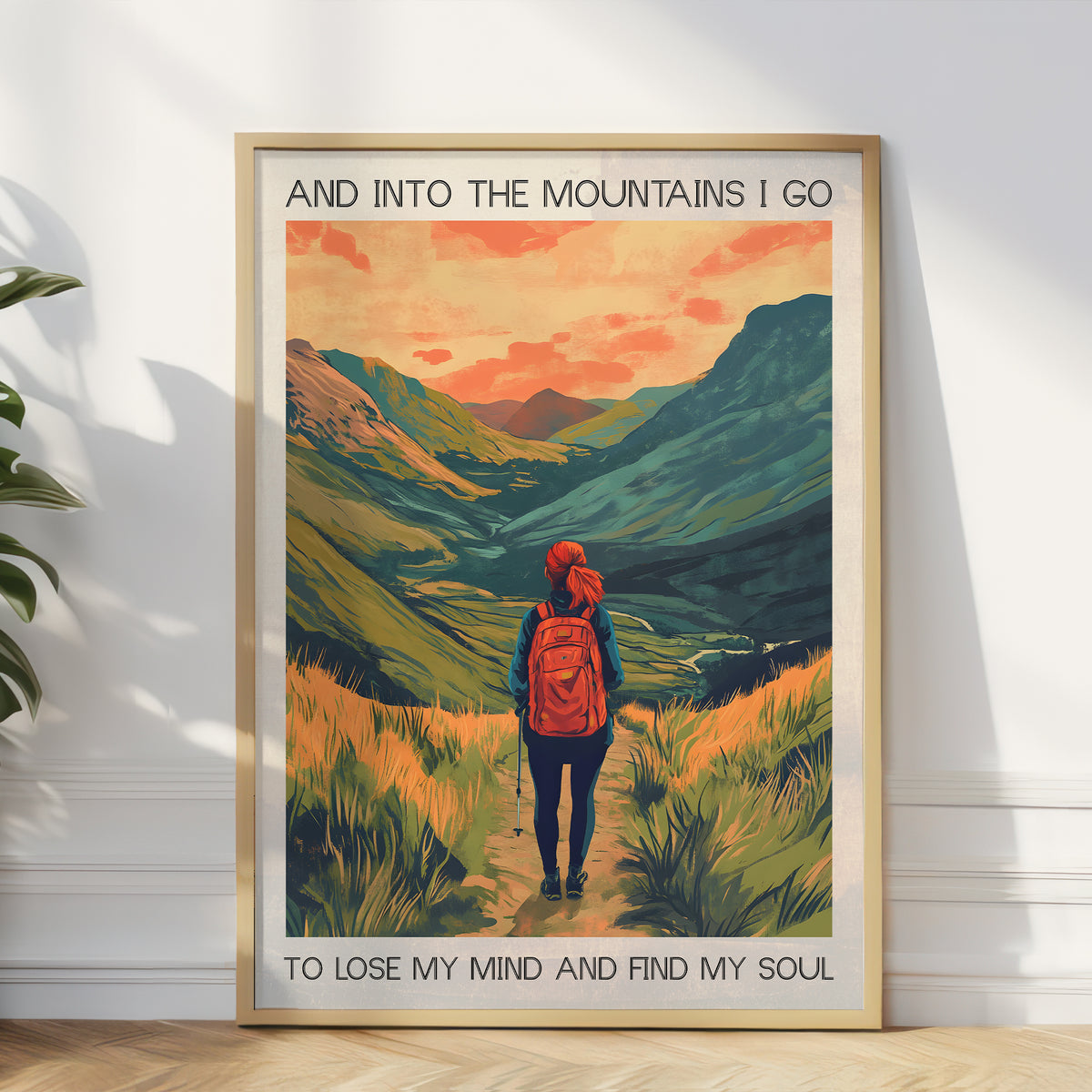 Framed poster of a hiker in the mountains with text on a white wall.