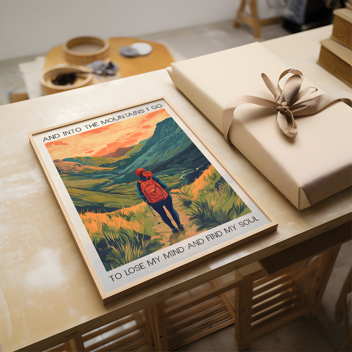 Poster of a person in a red jacket with text on a table next to a wrapped gift.
