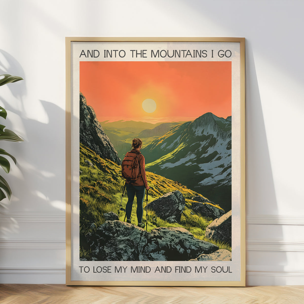 Framed poster of a person hiking with mountains and sunset in the background.