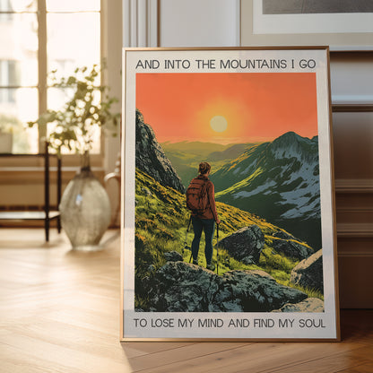 Framed poster of a mountain scene with a person and text in a room with a window and plant.