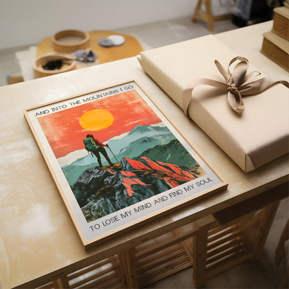 Poster of a hiker in the mountains with a gift on a wooden table.