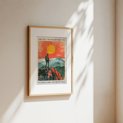 Framed artwork of a mountain scene with a person hiking, on a beige wall.