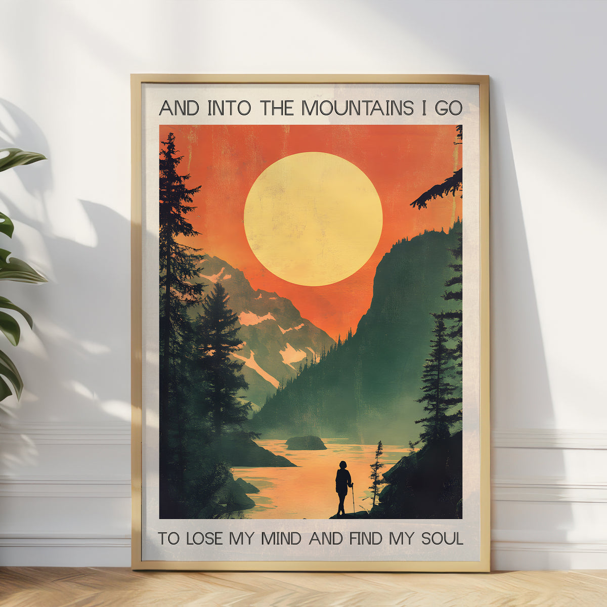 Framed poster with mountain scene and text on a white wall.