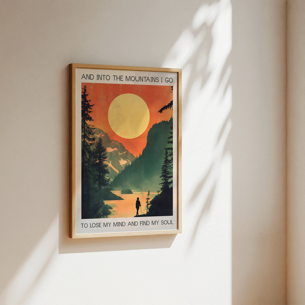 Framed poster with a mountain scene and text on a wall.