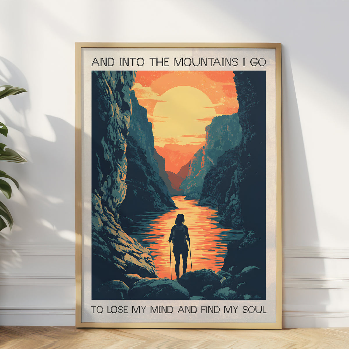 Framed poster of a mountain landscape with a person walking along a river, featuring text 'And into the mountains I go to lose my mind and find my soul'.