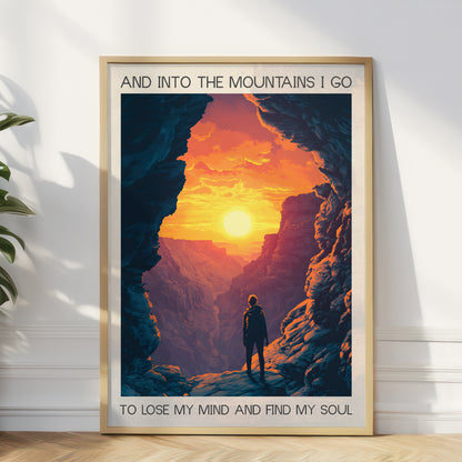 Framed poster of a mountain landscape with a person standing in a cave, sunset, and text.